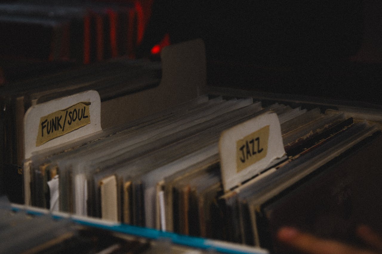 Collection of funk, soul, and jazz vinyl records sorted in a dimly lit environment.